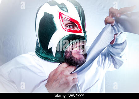 Shocked, angry businessman with Mexican wrestler mask, expressions of anger and rage Stock Photo