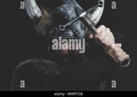 Ancient, Viking warrior with iron sword and helmet with horns Stock Photo