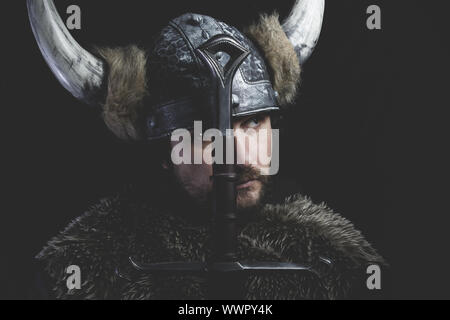 Leadership, Viking warrior with iron sword and helmet with horns Stock Photo