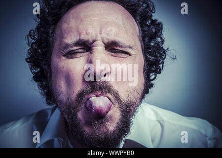 derision, man with intense expression, white shirt Stock Photo