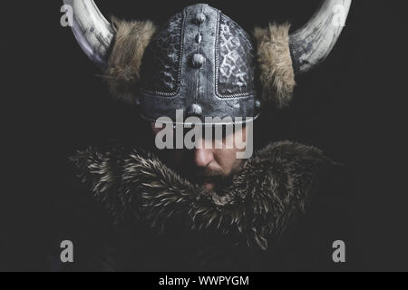 Danger, Viking warrior with iron sword and helmet with horns Stock Photo