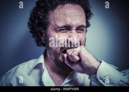 derision, man with intense expression, white shirt Stock Photo