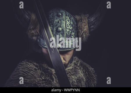 Conflict, Viking warrior with a huge sword and helmet with horns Stock Photo