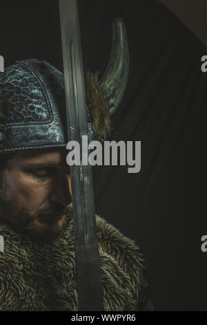 Viking warrior with iron sword and helmet with horns Stock Photo