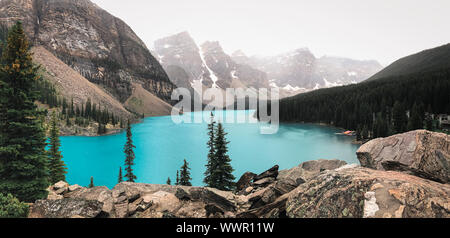 Foggy morning view of Moraine Lake and surrounding mountains. Stock Photo