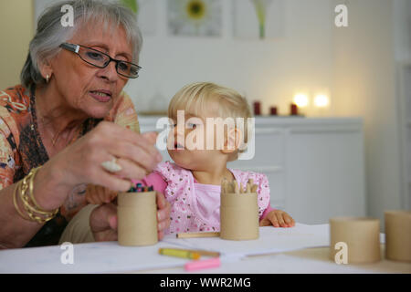 Young child coloring with grandma Stock Photo