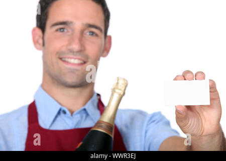 A sommelier holding up a blank business card Stock Photo