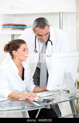 Doctors looking at a computer Stock Photo
