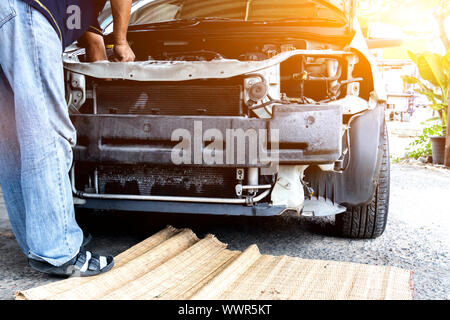 Mechanic repairs car and maintains vehicle in garage. Driving and transportation concept. Stock Photo