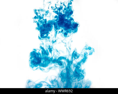 Poster color in water. Abstract background., Color paint drops in water. Ink swirling underwater, Cloud of silky ink collision on white background. Co Stock Photo