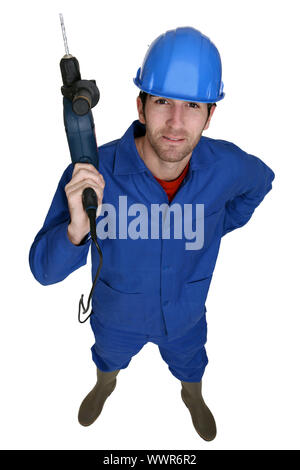 Tradesman holding up an electric screwdriver Stock Photo