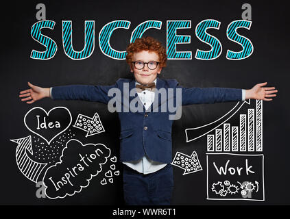 Young boy in blue suit against success concept Stock Photo