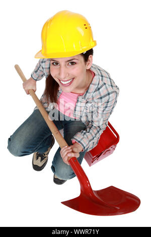 Female worker with a shovel Stock Photo