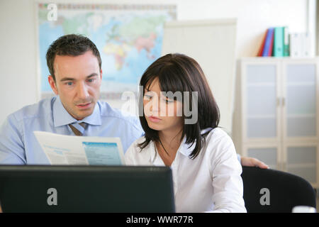 Business colleagues going over financial results Stock Photo