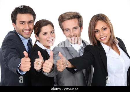 Four young professionals giving the thumbs up Stock Photo