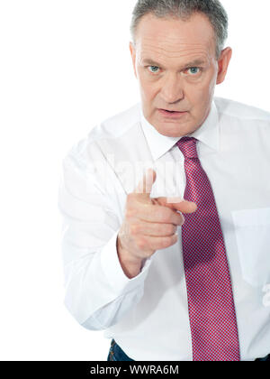 Portrait of an angry middle aged businessman in suit pointing at you isolated over white background Stock Photo