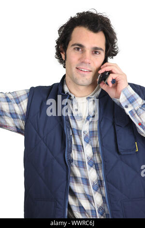 Workman using a cellphone Stock Photo