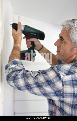 Handyman using drill Stock Photo