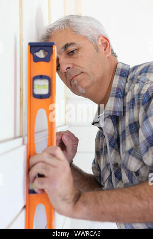 Handyman using spirit level Stock Photo