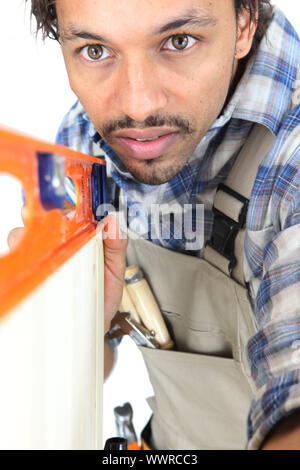 Tradesman using a bubble level Stock Photo