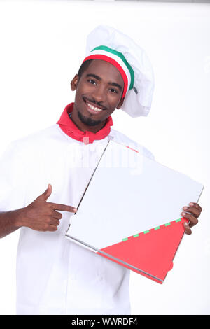 Italian themed chef pointing at a take out pizza box Stock Photo