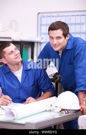 Two factory workers in the office checking stock Stock Photo