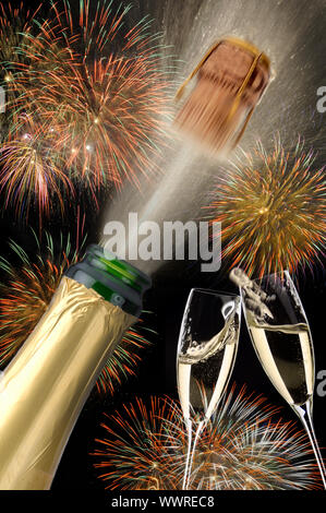 Champagne with flying cork and fireworks on New Year's Day Stock Photo