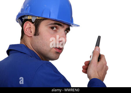 Builder using a walky talky Stock Photo