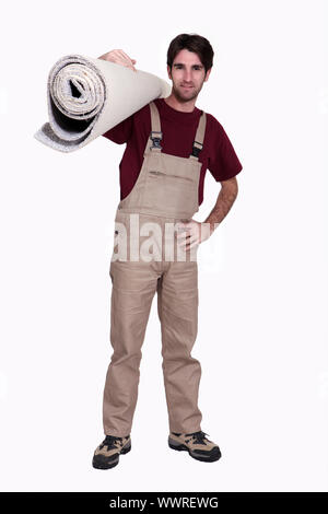 Man with a roll of carpet Stock Photo