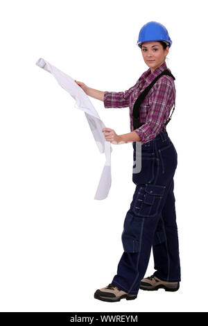 Female builder looking at plans Stock Photo