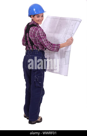 female construction worker watching a blueprint Stock Photo