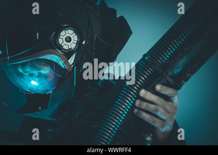 Space man with metal helmet and laser beam weapon Stock Photo