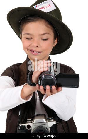 portrait of a little girl dressed as a photographer Stock Photo