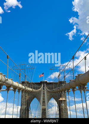 A view of the Brooklyn bridge with a blue sky on the background. Stock Photo