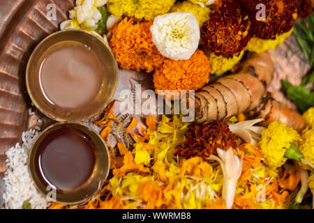 Close up shot puja thali containing flowers, chandan, turmeric, marigold, haldi, kumkum for durga, kali puja preparations. Stock Photo
