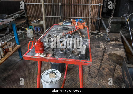 Various sized spanners and assorted tools in engineers workshop. Stock Photo