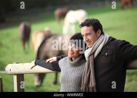 Couple standing in a paddock Stock Photo