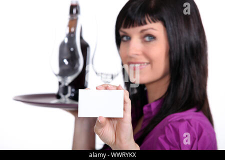 Sommelier holding up her business card Stock Photo