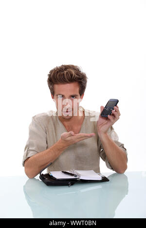 Man with a personal organizer demonstrating cellphone Stock Photo