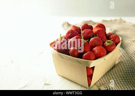 Big wooden boxes with fresh strawberries isolated on white background Stock Photo