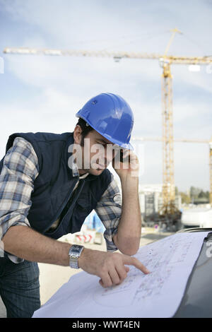 Foreman checking plan Stock Photo