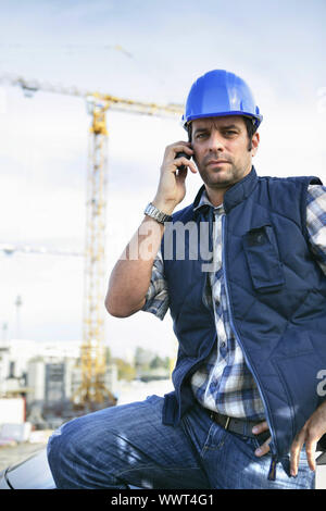 foreman in construction site making a call Stock Photo