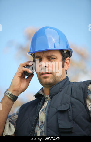 foreman in construction site making a call Stock Photo