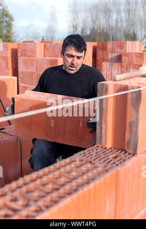 mason on a construction site Stock Photo