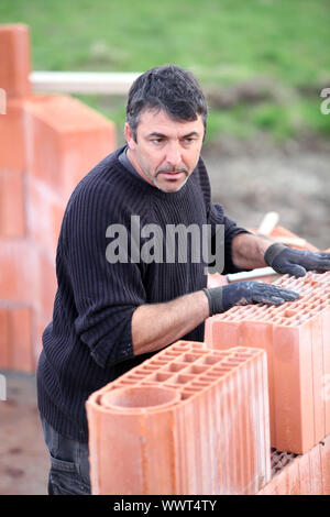 A hard-working bricklayer Stock Photo