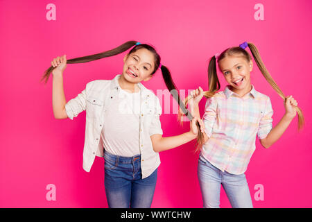 Close up photo two pretty little age girls holiday having fun childish glad tongue out mouth blinking playing wearing casual jeans denim checkered Stock Photo
