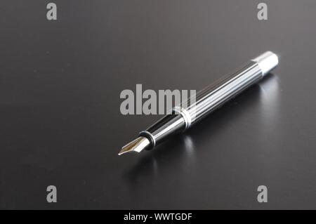 pen showing communication contact us or mail concept on black background Stock Photo