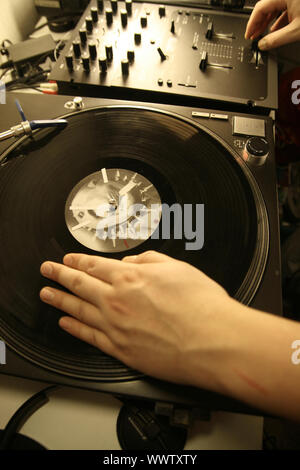 scratch battle of dj playing on his vinyls hand on Stock Photo