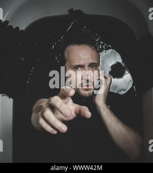 Horror, Fallen angel, man in a bathtub with black water and wings, submerged, depression, loss Stock Photo