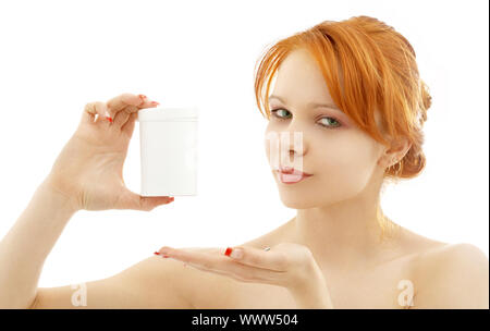 lovely redhead showing blank medication container over white Stock Photo